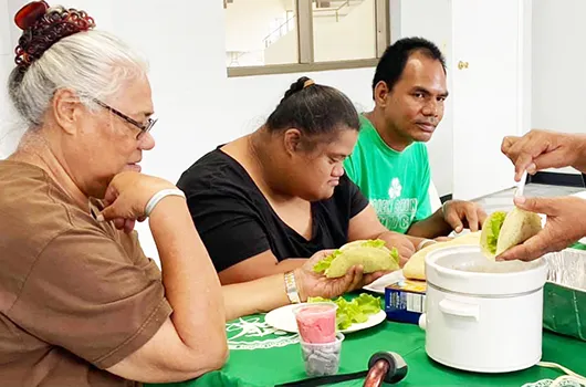 Parents with their special needs children learning how to make tacos