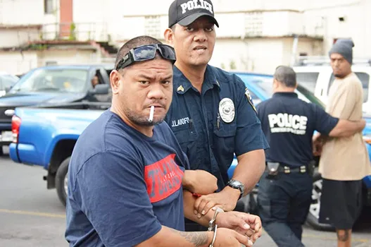 Defendant, Pati Lepou with a police officer 