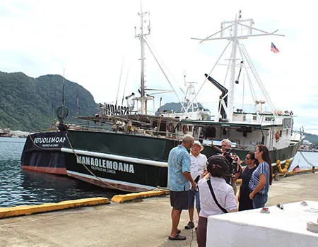 Facing the camera, Carlos Sanchez, a co-owner of several US- American Samoa based longliners is seen with the PBS TV crew.