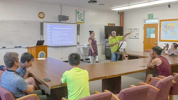 Translator Program Manager Autagavaia Tunai Alfred Peters explain proper pesticide disposal procedures