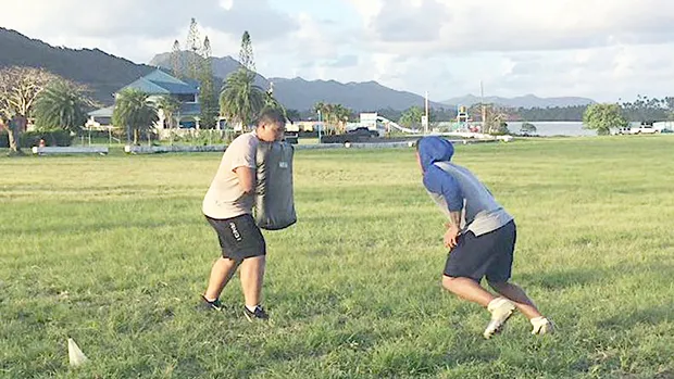 Two high school football players working out