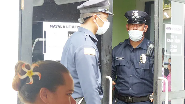 The two police officers exiting DHSS office