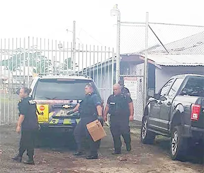 Some of the police officers who conducted a shakedown at the TCF standing outside the gate.