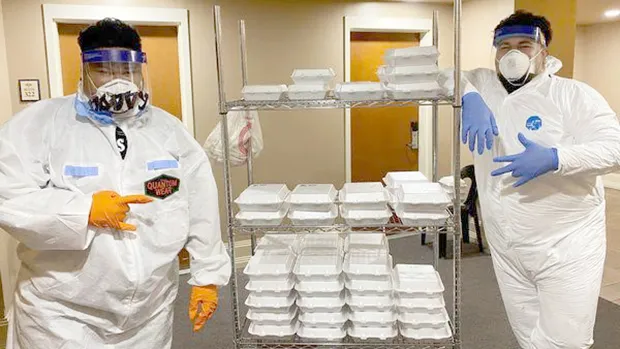 Protected workers deliver meals at a quarantine site in Am Samoa