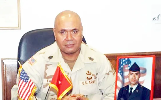 CSM retired Faleniko with a photo of his son, Jonathan.