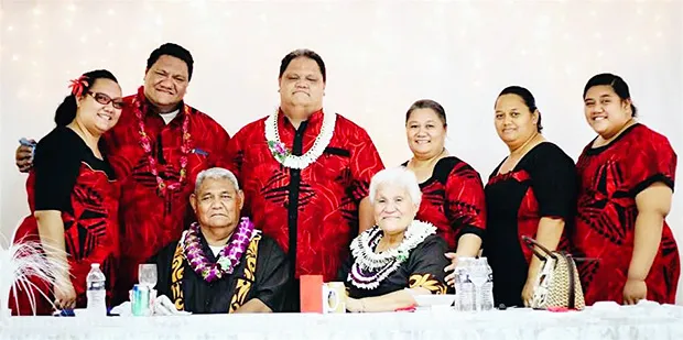 This  family photo shows the late Rev. Elder Dr. Pati Puia’i Vaeao sitting next to his wife of 47 years, Siafiafilelei Thompson Leasau, surrounded by family members
