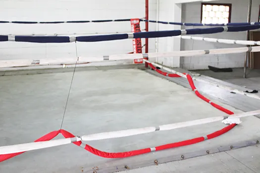 Ring rope cut and laying on floor of boxing ring
