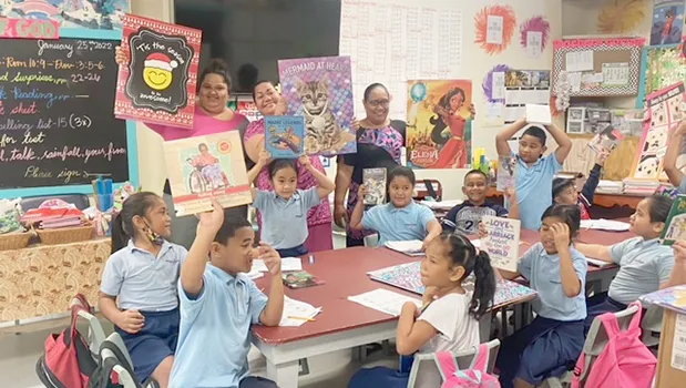 1st grade students and teachers with their new books and posters