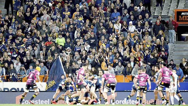 Rugby match in New Zealand with fans in the stands