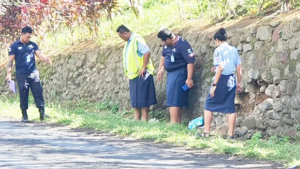 Samoa police beside the rock wall where the accident happened
