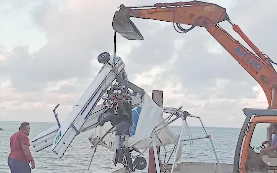 plane crash debris being lifted from the sea