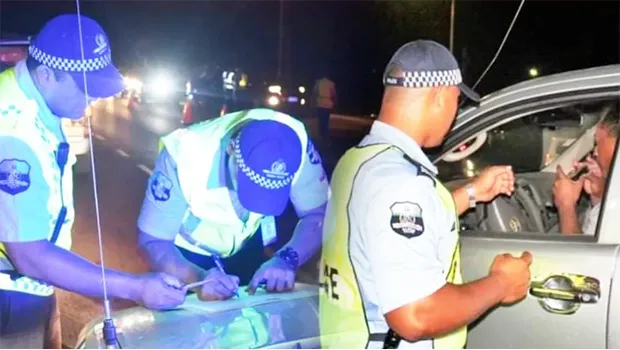Police officers at road block questioning motorist