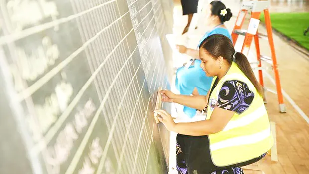 Samoa votes being tallied by young woman at blackboard