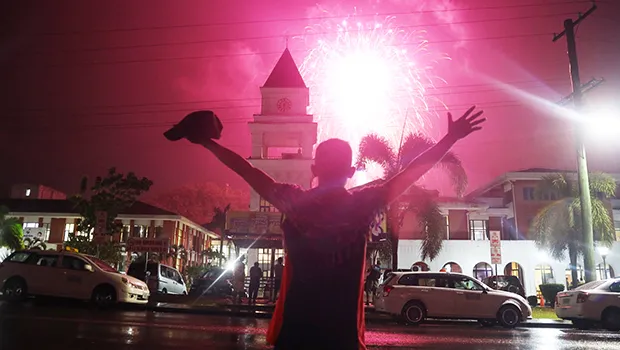 Man watching fireworks light up the sky in Apia on New Year's 2022