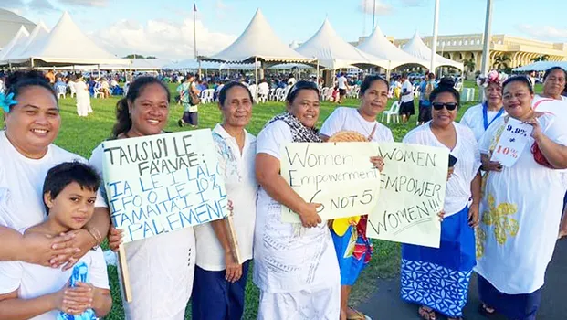 women with signs supporting an additional slot for women in parliament