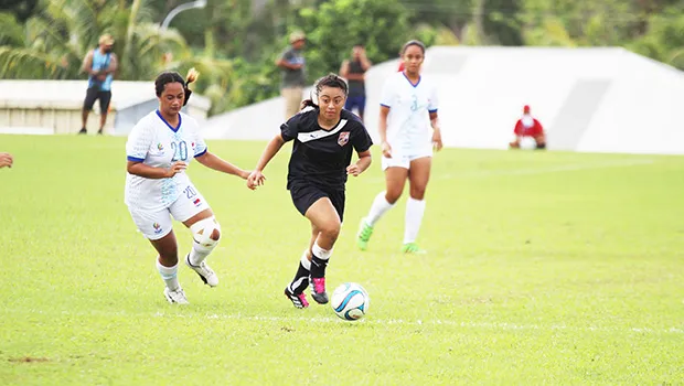 Saono Enesi of American Samoa, right, dribbles away
