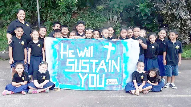 Samoa Baptist Academy 1st graders with their banner