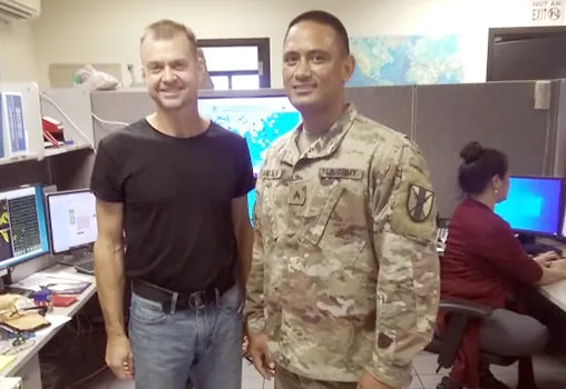Scott Rozanski (left) in Weather Service office with another staff member