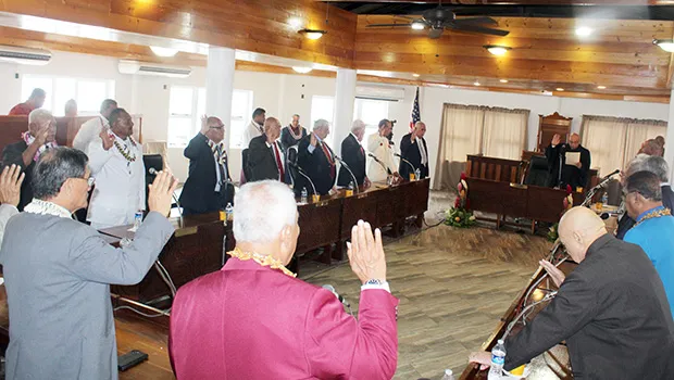 Senators with their hands raised taking oath