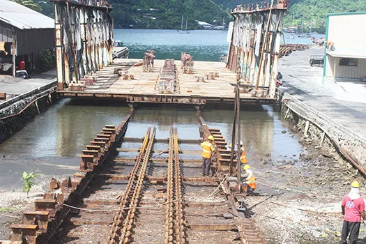 Ronald Reagan Shipyard employees working on repairs to the front portion of the 3,000-ton slipway at Satala yesterday morning. 