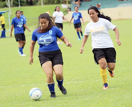 Samoana Sharks’ Deidra Steffany (left) defends against Fa’asao-Marist Cougars’ Lourdes Afoa