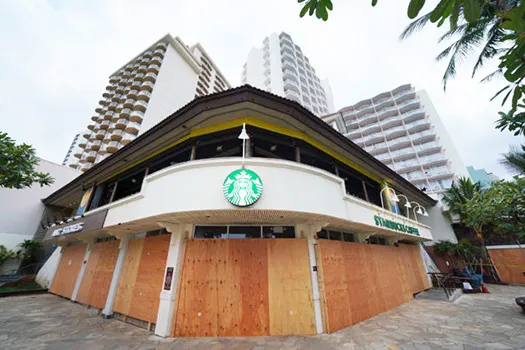 A Waikiki Starbucks coffee shop near Kapahulu Avenue with windows boarded up