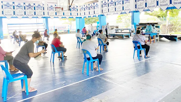 Parents picking up food coupons at Samoana H.S.