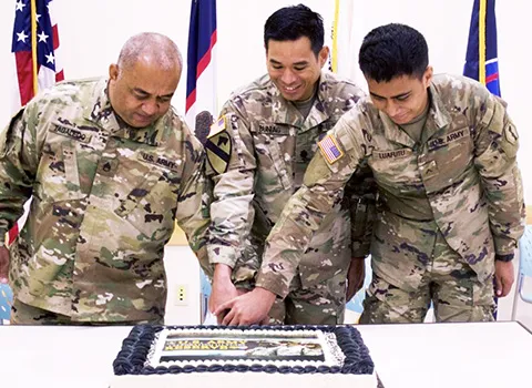 Staff Sgt. Faiupu Tagaleoo, assigned to Theater Support Group American Samoa Detachment, 9th Mission Support Command (left), representing the oldest unit member, and Pvt. Vend Luafutu, assigned to Charlie Company, 100th Battalion, 442nd Infantry Regiment, 9th Mission Support Command (right), along with Lt. Col. Alejandro Buniag, Commander, Theater Support Group American Samoa Detachment