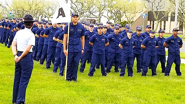 In this photo from the U.S. Coast Guard Family Facebook page. Alaimaleata is leading the whole unit (front) holding the flag.  [courtesy photo]