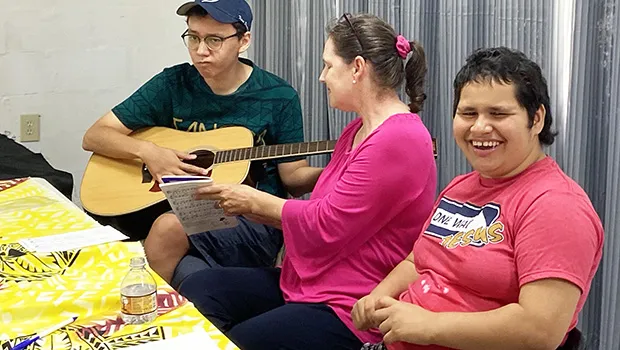 Special needs kids with a parent enjoying making music.