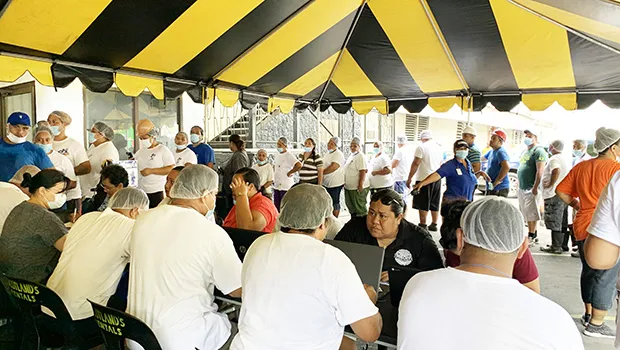 Health Department medical personnel giving measles shots to StarKist Samoa workers