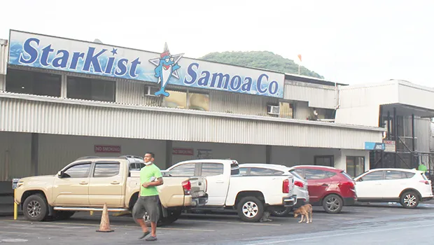 Man walking by StarKist Samoa canning plant