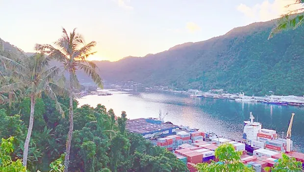 Sun just behind the mountains as it rises over Pago Pago bay