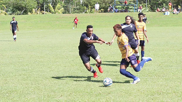 Takai Pouli of American Samoa defends against a Tuvalu opponent