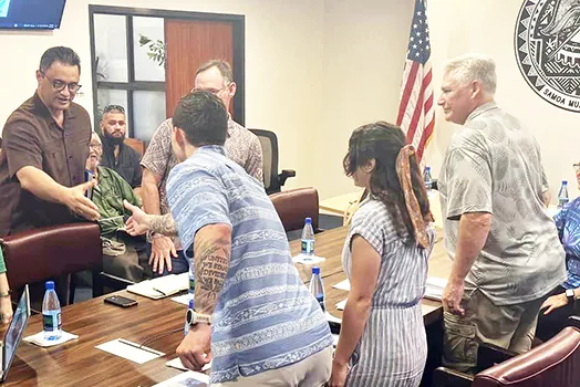 Talauega shakes hands with Army Corps officials