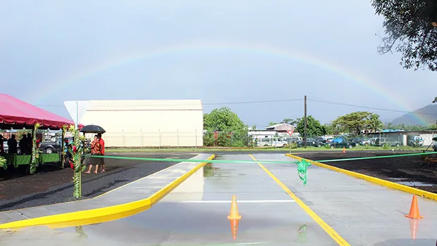 Rainbow over the Tasi Street Extension dedication ribbon