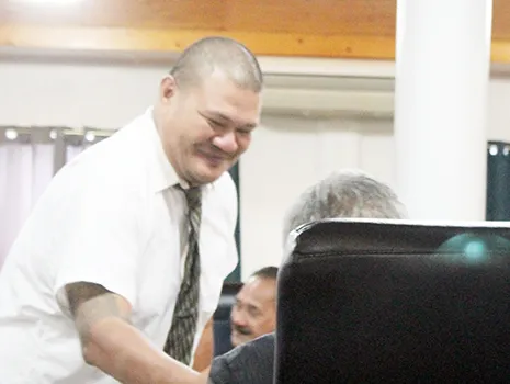 ASG Tax Office Manager Vaaimamao E. Poufa shaking hands with a Senator