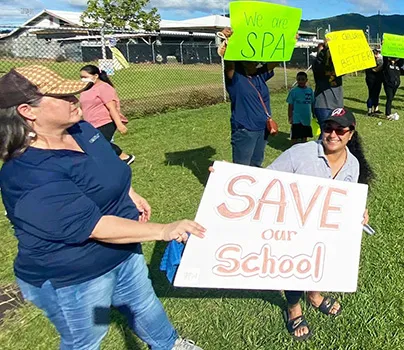 Teachers and demonstrators last week hold signs at SPA