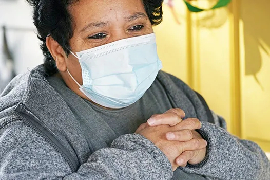 Evelyn Maysonet, 53, looks on as food is provided 
