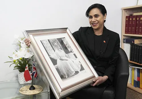 Tonga High Commissioner to the UK, Titilupe Fanetupouvava'u Tu'ivakano with photo of her great grandmother, Queen Salote