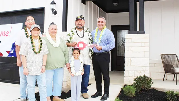 Retired U.S. Army Sergeant First Class Vaitogi Sani Taetuli and his family in front of their new home.