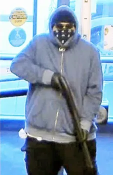 Totoe Opeti Sakaria, Jr., who is masked, wearing sunglasses and holding a shotgun