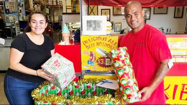 Tiara Drabble (left) received two gifts from a Cost-U-Less employee for the Le Taupou Manaia Dance Academy “Toys & Joy Drive for Samoa” this past Dec. 2019