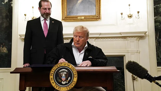 President Donald Trump signs an $8.3 billion bill to fight the coronavirus