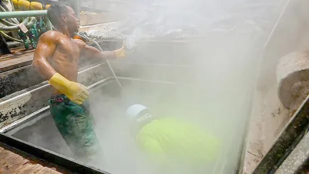 Two tuna fishermen working on deck
