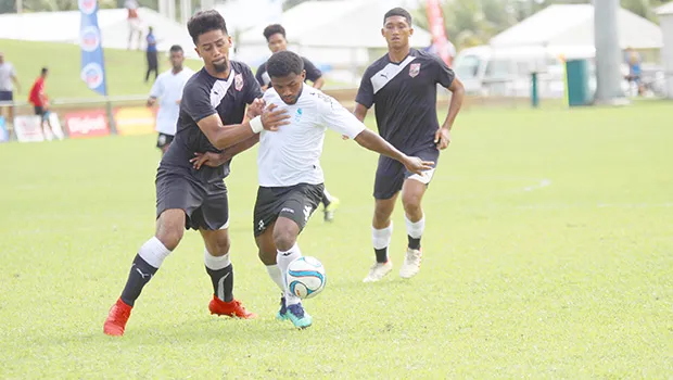 Ueli Tualaulelei (left) of American Samoa defends