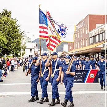 Leonrhee K. Alaimaleata carrying USCG flag in formation