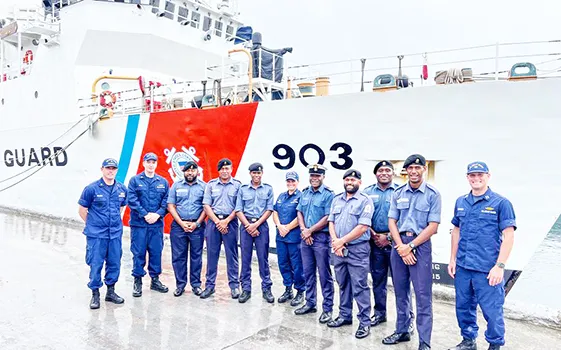 U.S. Coast Guard and Fiji Navy personnel stand in front of USCG cutter