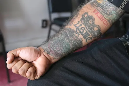 Julio Torre shows his USMC tattoo