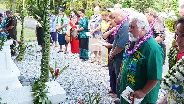 Utu Abe Malae's gravesite surrounded by people who attended his 1 year memorial service